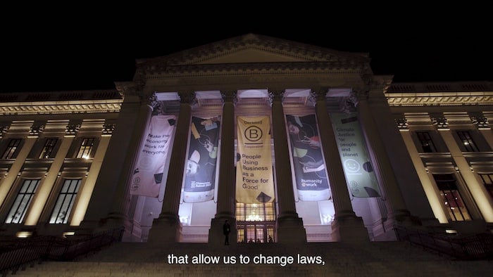 b corp champions retreat banner hanging in front of a historical building