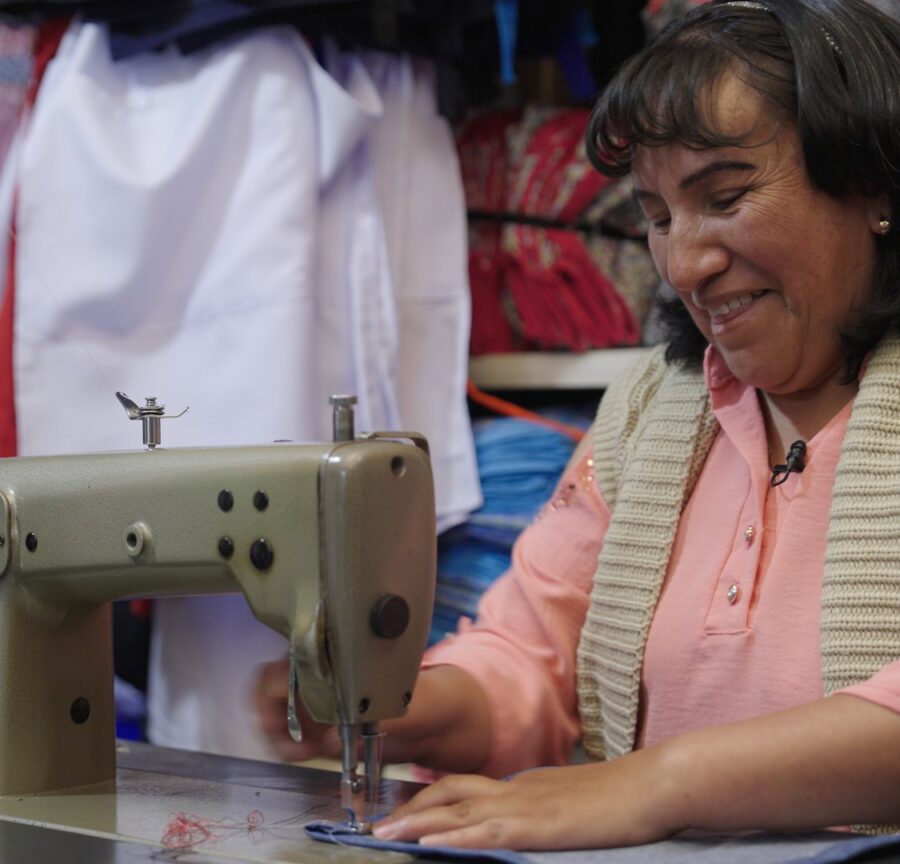 woman works at a sewing machine, a beneficiary of a fixed-life foundation legacy